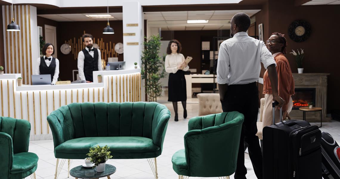 African American Couple Reception Arriving Hotel Preparing Check Process Happy Man Woman Asking Front Desk Staff About Room Reservation Fill Registration Forms