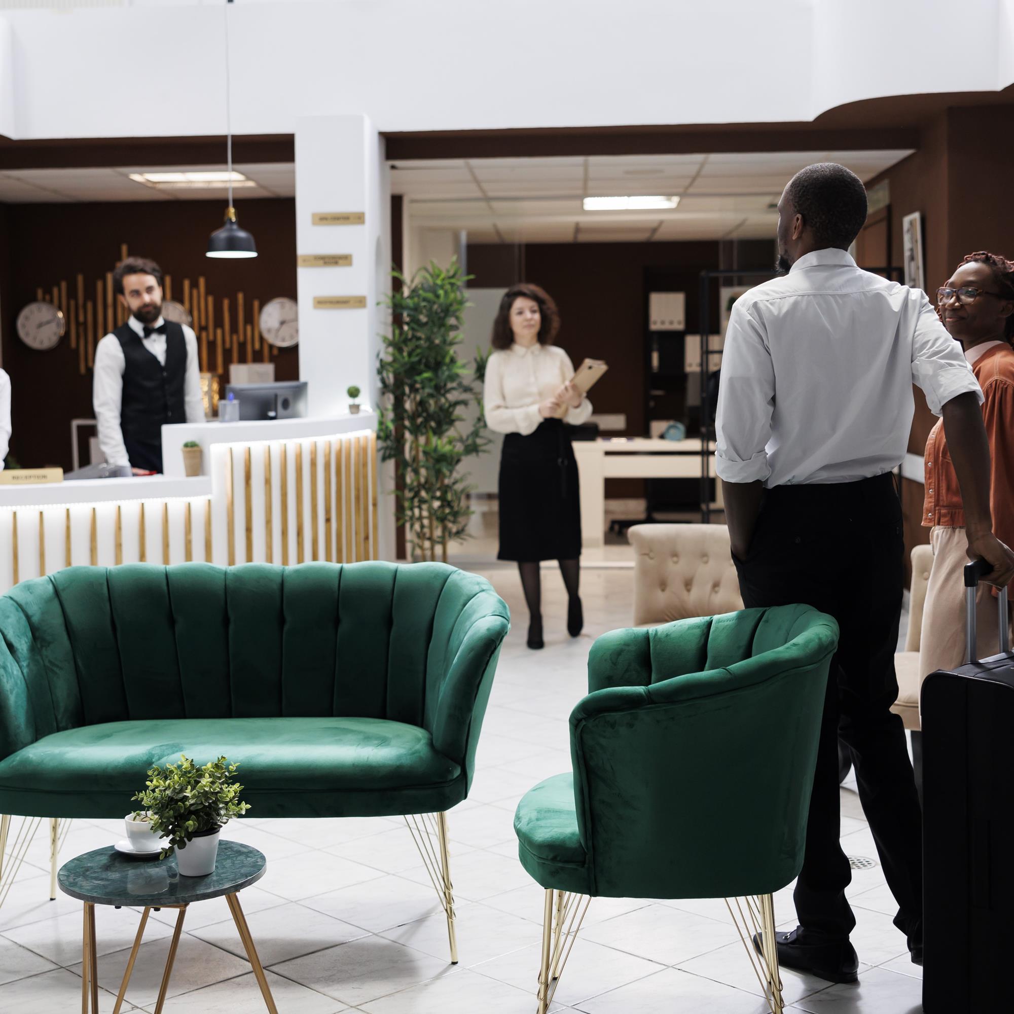 African American Couple Reception Arriving Hotel Preparing Check Process Happy Man Woman Asking Front Desk Staff About Room Reservation Fill Registration Forms