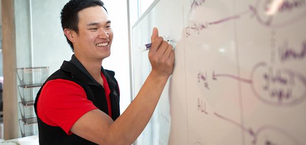 Male Intern Writing on Whiteboard