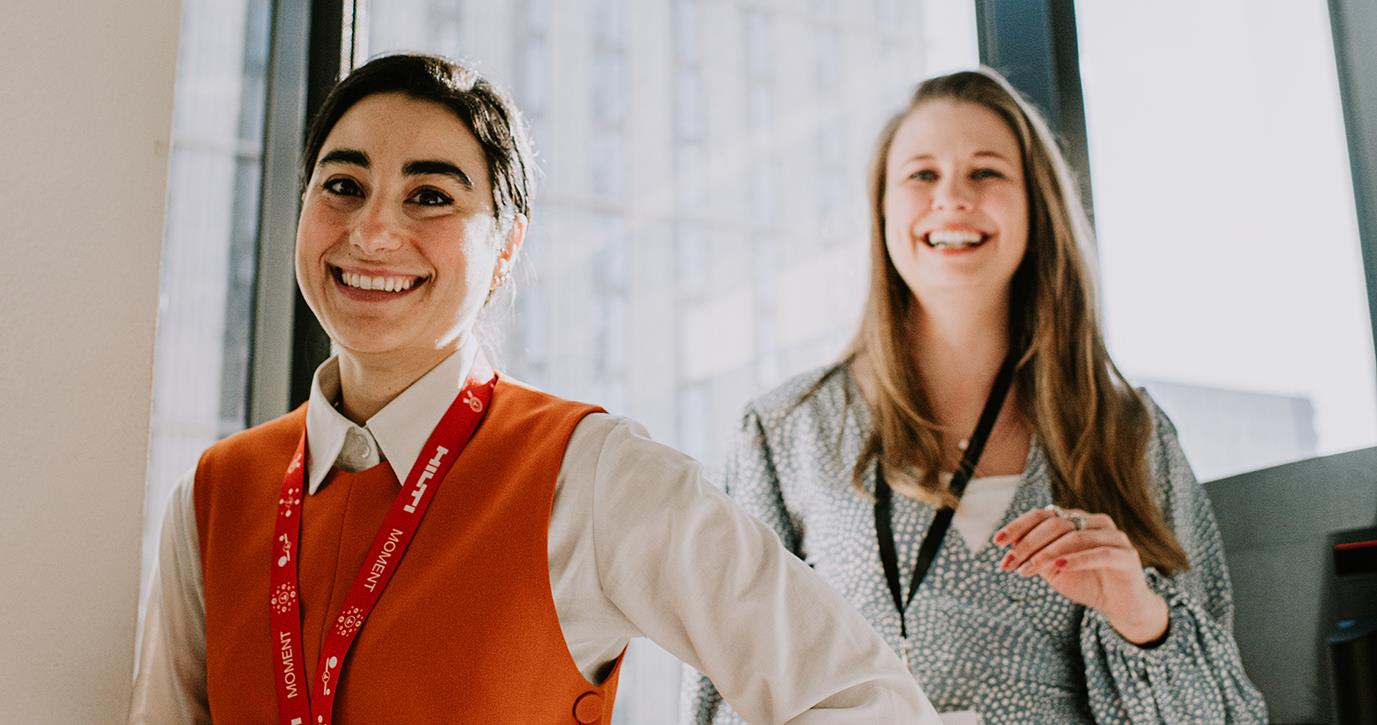 Two Female Employees Standing in Sunlight