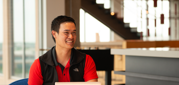 Male in Hilti Game Area Working on Computer