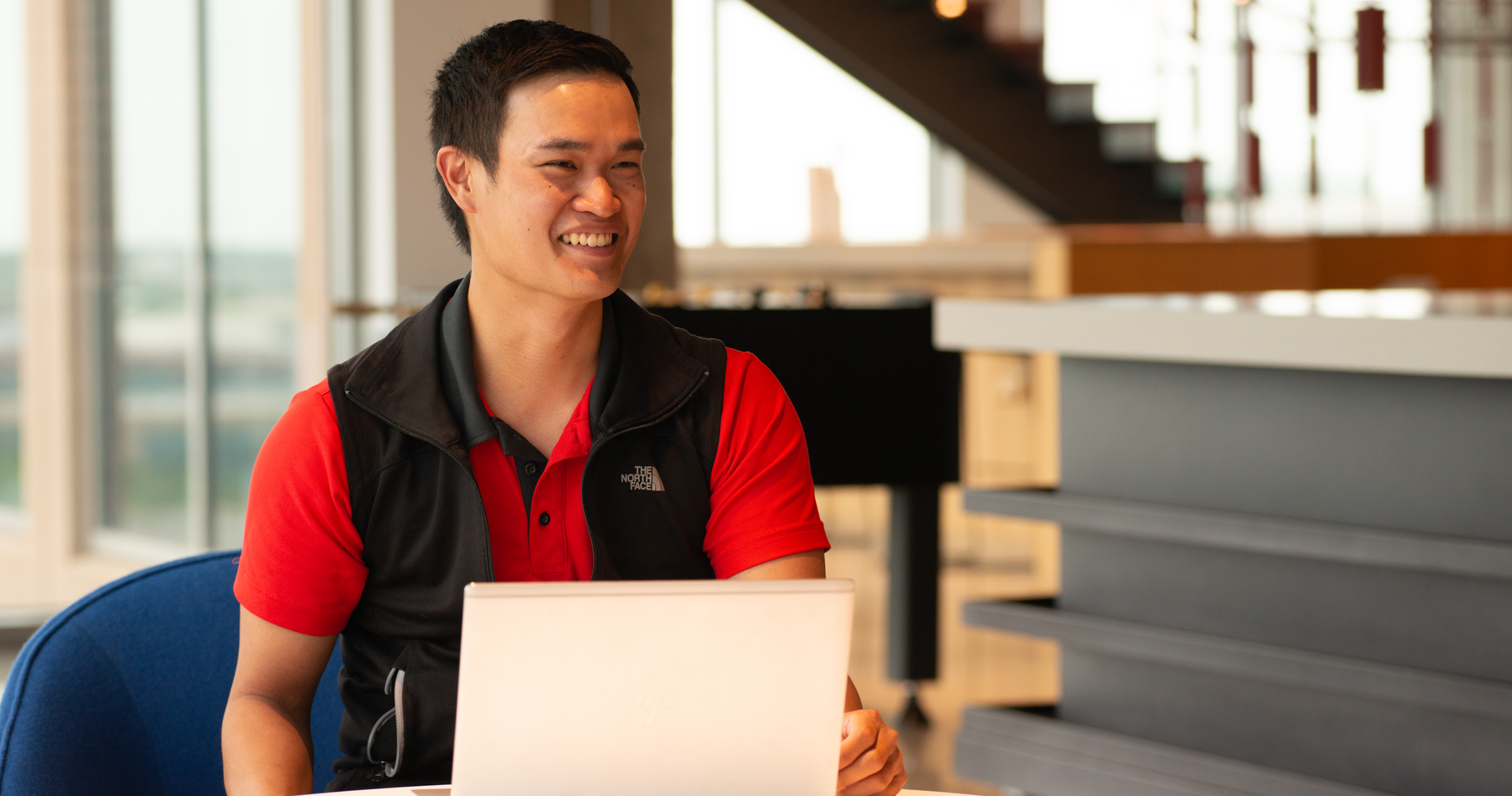 Male in Hilti Game Area Working on Computer