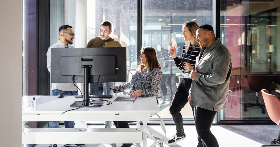 Group of Team Members Learning Around Computer Together