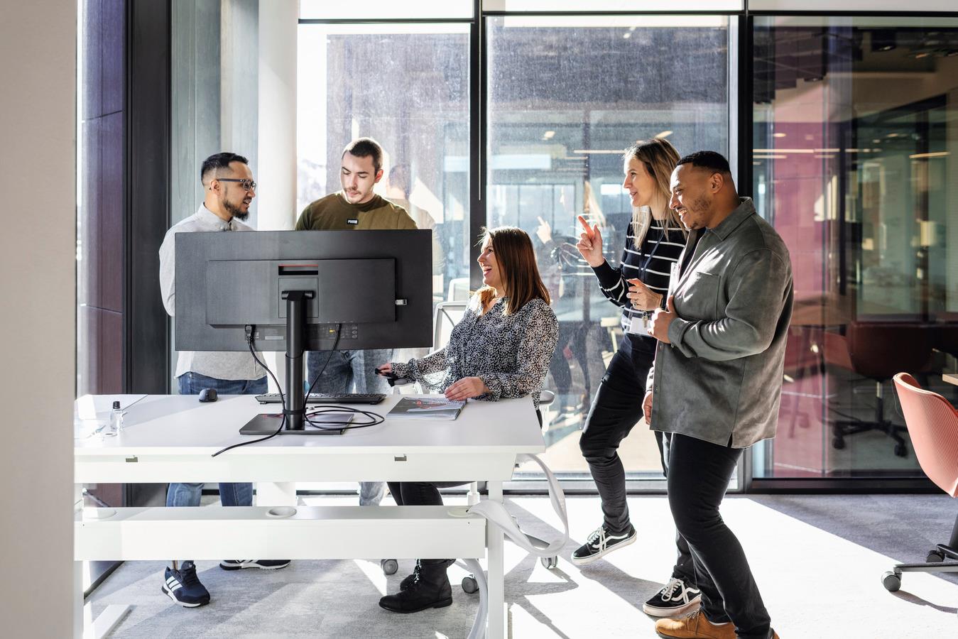 Group of Team Members Learning Around Computer Together